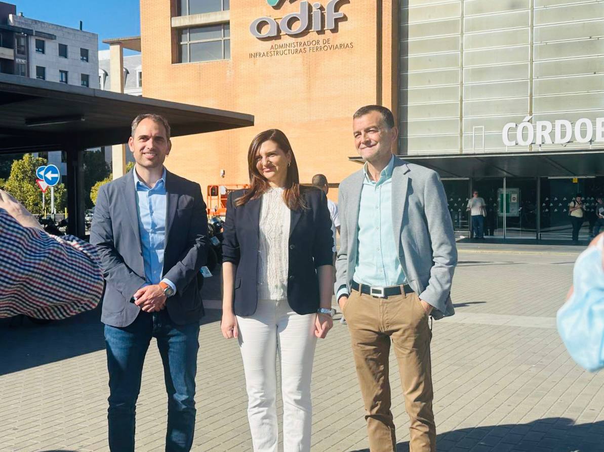 Ana Anguita, flanqueada por Antonio Maíllo y Toni Valero, además de otra de conjunto de las personas asistentes hoy al breve acto a las puertas de la que se denominará 'Estación Córdoba - Julio Anguita'